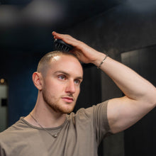 Action shot of a user employing the scalp massager, demonstrating its ease of use and comfort.