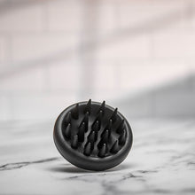 Scalp massager elegantly displayed in a styled photoshoot, highlighting its modern aesthetics.